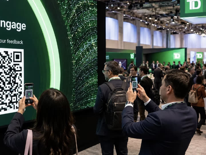 Guests at a convention center booth scanning a DMA Engage QR code